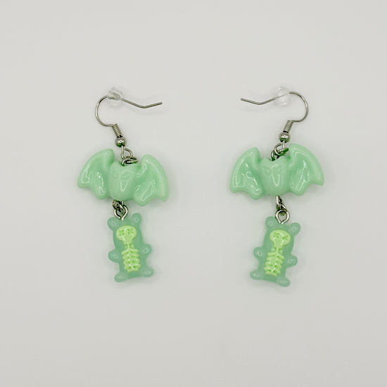 Two Moody Originals Candy Bite Bat Earrings in mint green with skeleton gummy charm