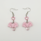 Two Moody Originals Candy Bite Bat Earrings in soft pink with heart connector and iridescent bead