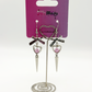 Two Moody Originals: Coquette Dagger Earrings displayed on branded packaging with silver heart charms featuring pink faux pearl accents, silver bows, and dagger drops.