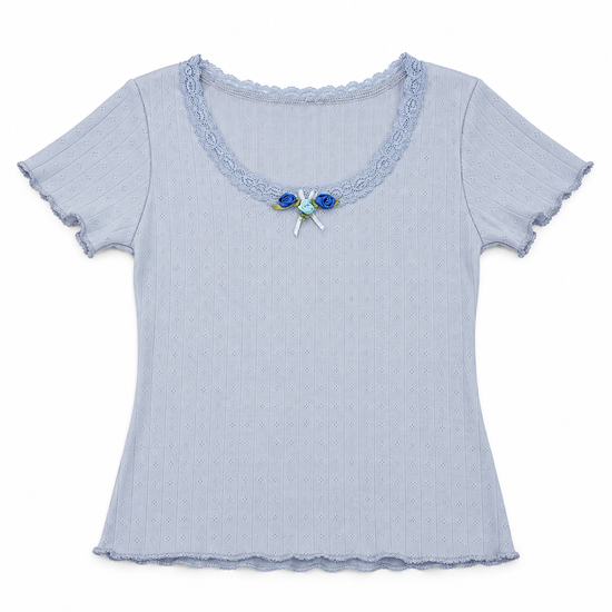 Front flat lay of the blue Two Moody Originals: Floral Daydream Top with pointelle texture, scalloped lace, and three blue rose appliqués with a bow.