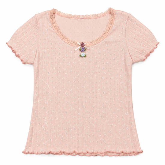 Front flat lay of the pink Sweet Dreams Two Moody Originals: Floral Daydream Top with a vertical row of multicolor rose appliqués and a bow. 