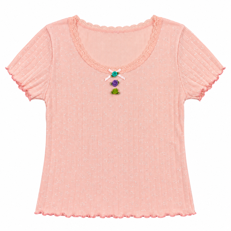 Front flat lay of the pink Vivid Dreams Two Moody Originals: Floral Daydream Top with a vertical row of multicolor rose appliqués and a bow. 