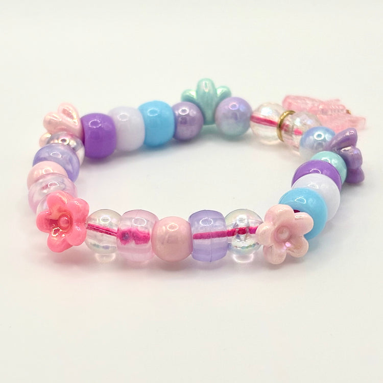Another angle of the Two Moody Originals: Kandi Bracelet in Daydream Wings, with a focus on the flower charms and beading