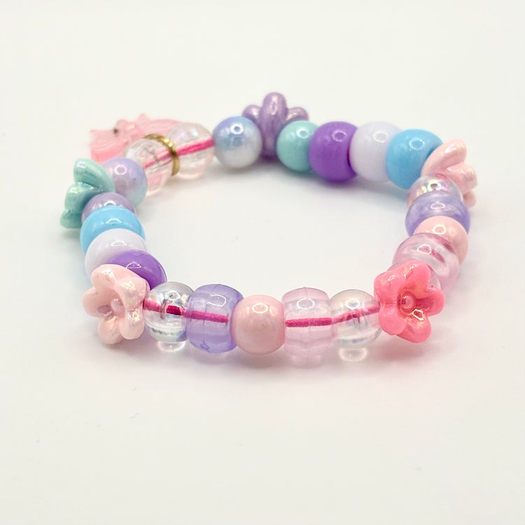Another angle of the Two Moody Originals: Kandi Bracelet in Daydream Wings, with a focus on the remaining flower charms and beading