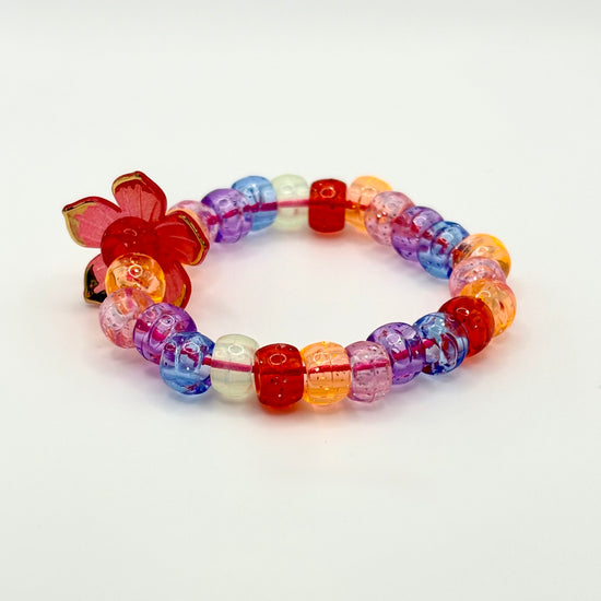 Another angle of the Two Moody Originals: Kandi Bracelet in Garden Sunset, showcasing the red flower charm with golden-tipped petals