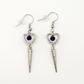 Two Moody Originals: Pierced Heart Dagger Earrings with silver open heart charms, blue crystal accents, and dangling silver dagger details.