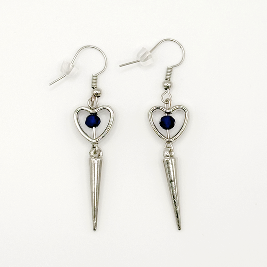 Two Moody Originals: Pierced Heart Dagger Earrings with silver open heart charms, blue crystal accents, and dangling silver dagger details.
