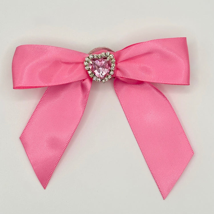 Front of the large decorated Two Moody Originals: Signature Bow Clips in the color pink with a heart rhinestone center