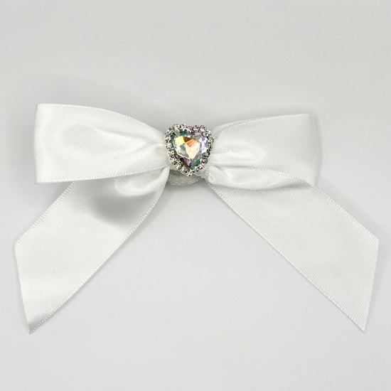 Front of the large decorated Two Moody Originals: Signature Bow Clips in the color white with a heart rhinestone center
