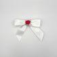 Front of the large decorated Two Moody Originals: Signature Bow Clips in the color white with a hot pink rose in the center