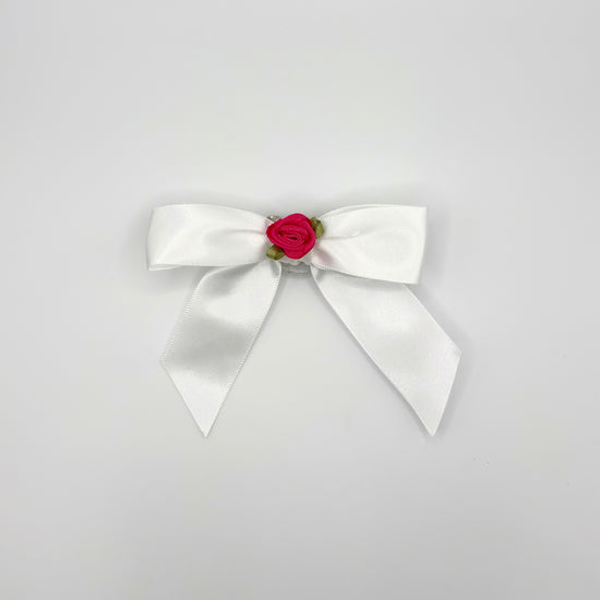 Front of the large decorated Two Moody Originals: Signature Bow Clips in the color white with a hot pink rose in the center