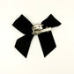 Back of the small classic Two Moody Originals: Signature Bow Clips in the color black, showcasing the alligator hair clip and brooch pin