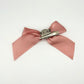 Back of the small classic Two Moody Originals: Signature Bow Clips in the color dusty rose, showcasing the alligator hair clip and brooch pin