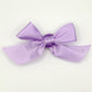 Front of the small classic Two Moody Originals: Signature Bow Clips in the color lavender