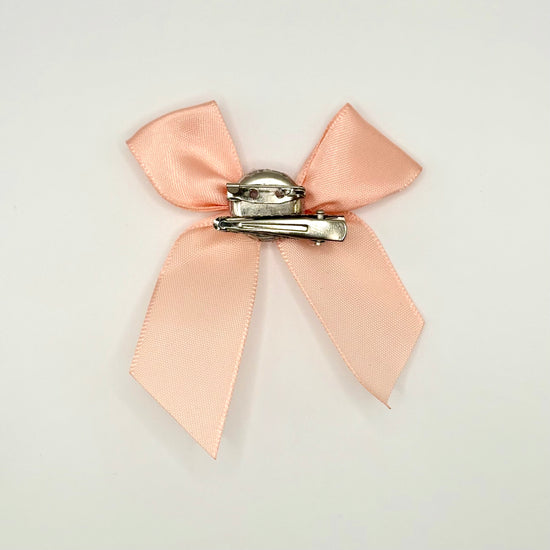 Back of the small classic Two Moody Originals: Signature Bow Clips in the color peach, showcasing the alligator hair clip and brooch pin