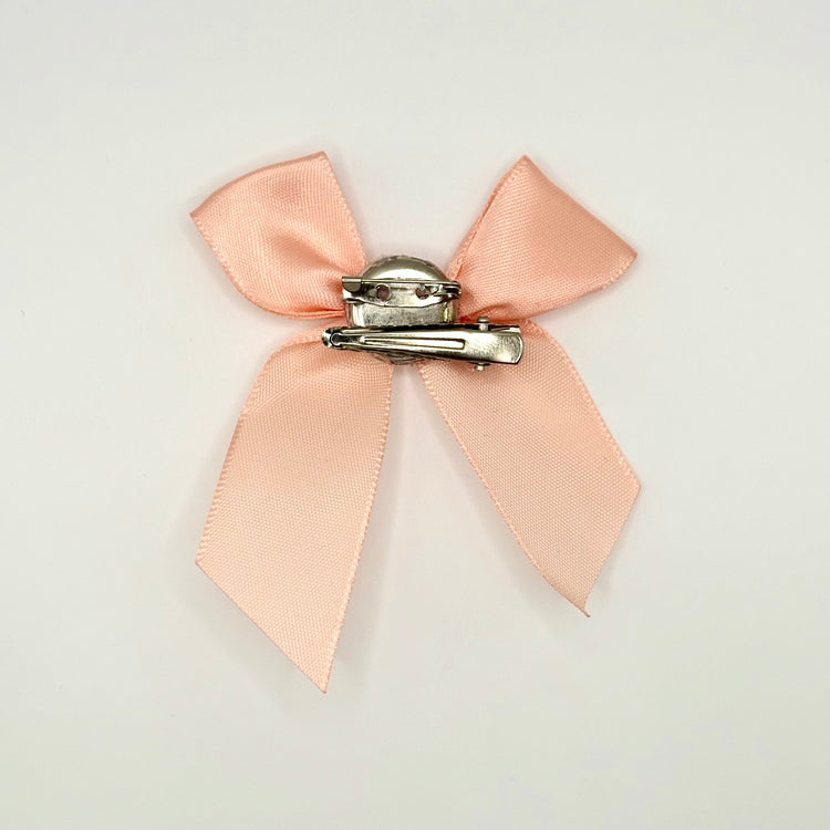 Back of the small classic Two Moody Originals: Signature Bow Clips in the color peach, showcasing the alligator hair clip and brooch pin