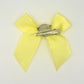 Back of the small classic Two Moody Originals: Signature Bow Clips in the color yellow, showcasing the alligator hair clip and brooch pin