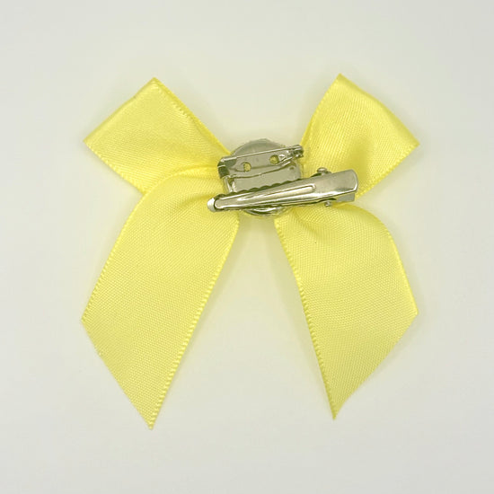 Back of the small classic Two Moody Originals: Signature Bow Clips in the color yellow, showcasing the alligator hair clip and brooch pin