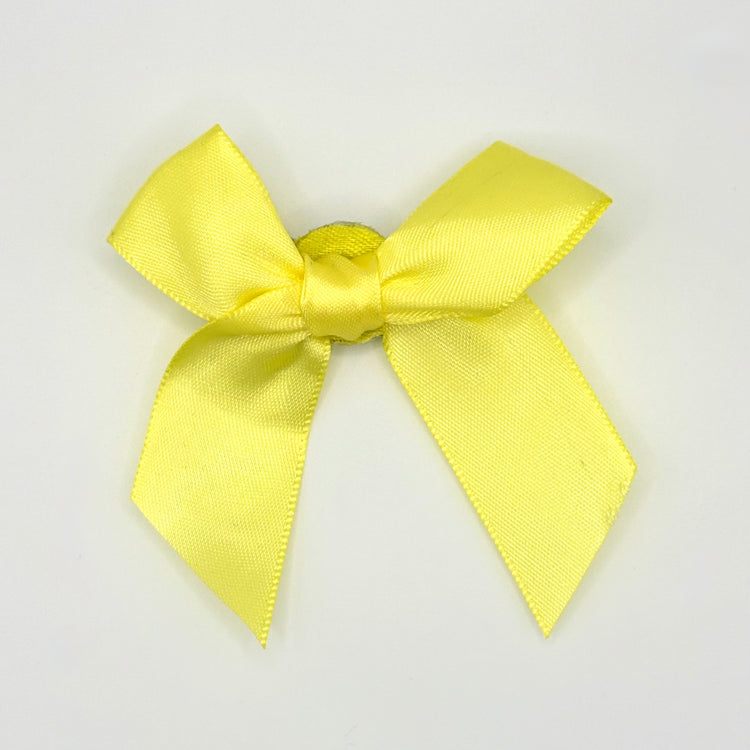 Front of the small classic Two Moody Originals: Signature Bow Clips in the color yellow