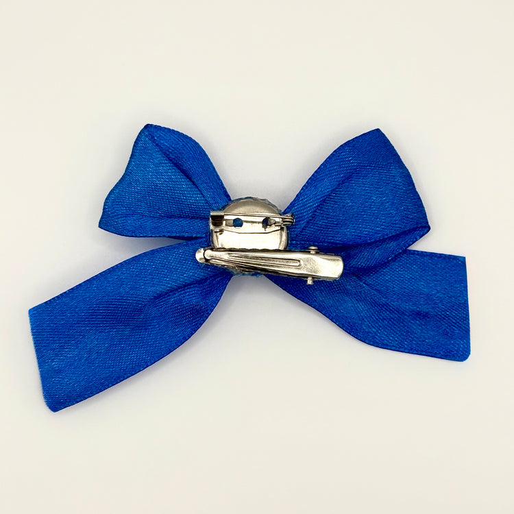 Back of the small decorated Two Moody Originals: Signature Bow Clips in the color royal blue, showcasing the alligator hair clip and brooch pin