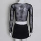 Back view of the Web of Shadows Mesh Top, featuring sheer black spiderweb mesh, full-length sleeves, and a cropped fit.