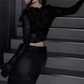 View of model wearing the Web of Shadows Mesh Top from the side, showcasing the sheer spiderweb mesh, cropped silhouette, and fitted design.