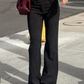 Model wearing black Y2K Business Chic Trousers with white pinstripes, standing front-facing