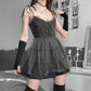 Three-quarters view of Dark Fairy Tulle Dress showing layered skirt and delicate tie straps, styled with arm warmers