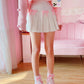 The Sweetheart Academy Skort styled with pastel sneakers and a cropped pink sweater